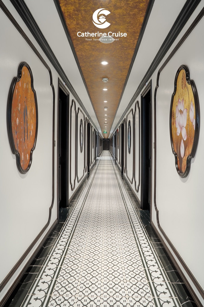 Elegant luxury cruise corridor with ornate wall art and patterned tile floor, showcasing high-end comfort.