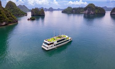 Aerial view of Heritage Cruise sailing through stunning limestone karsts in Halong Bay, Vietnam.
