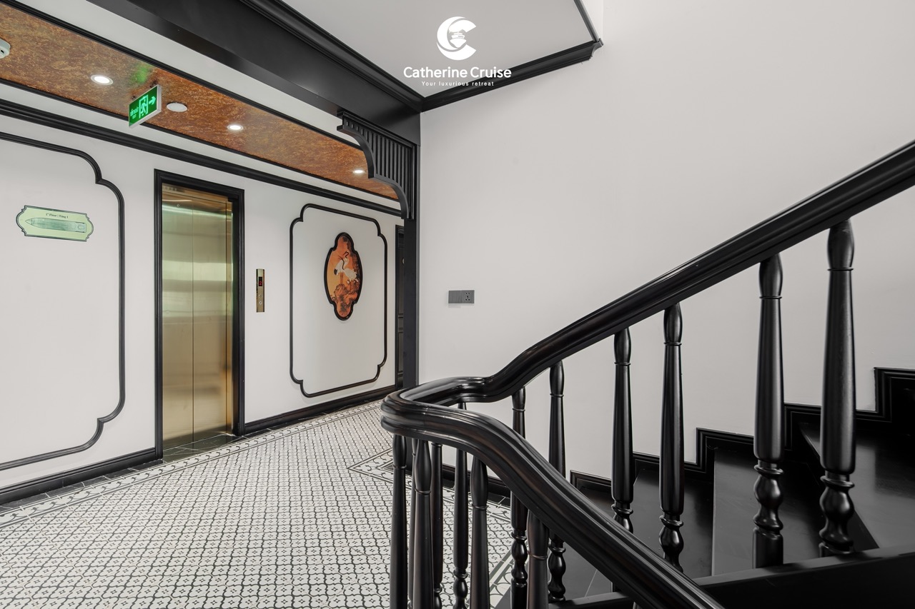 Elegant elevator and staircase interior at ViettrendTour cruise, luxury travel experience.