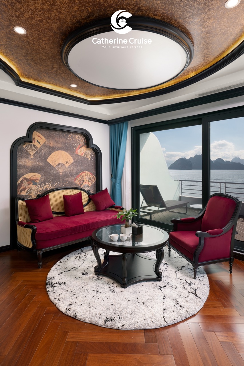 Luxurious cruise lounge with sea view, red velvet furniture, elegant decor, and balcony overlooking mountains.
