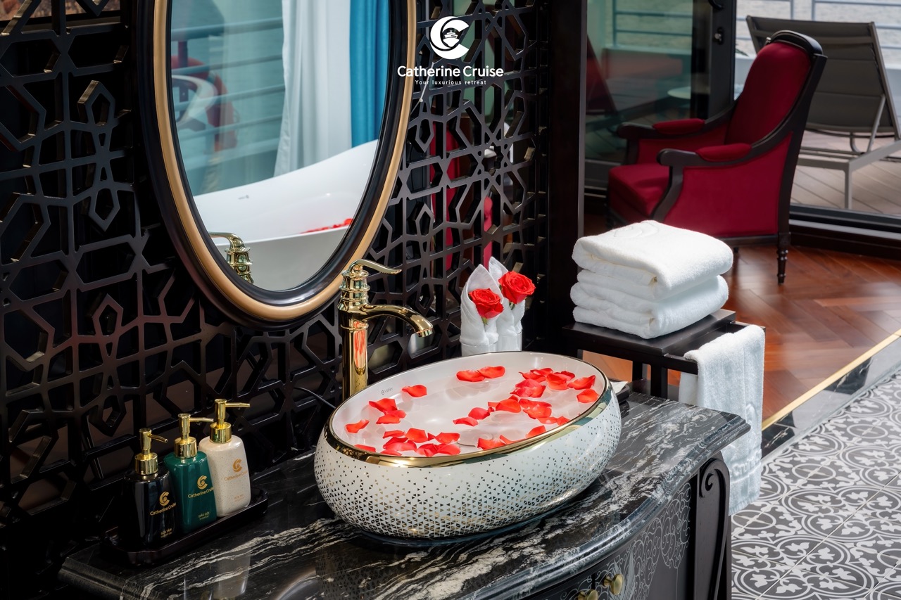 Luxurious bathroom with rose petal bath, towel stacks, and elegant decor for relaxation.