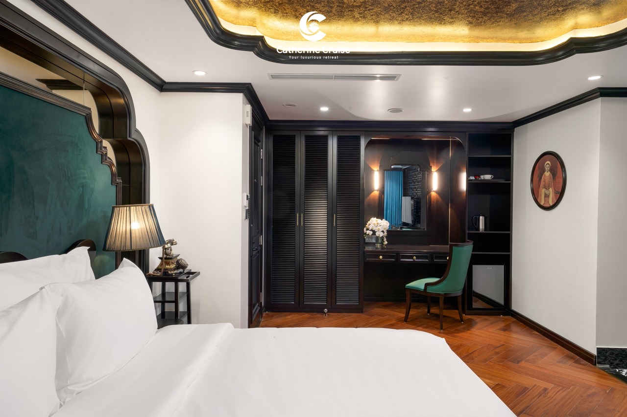 Luxurious hotel bedroom with modern decor, dark wood accents, and elegant lighting.