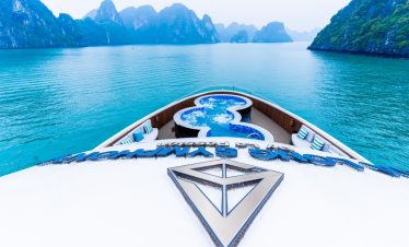 Stunning view from the cruise balcony overlooking Halong Bay's emerald waters and limestone karsts.