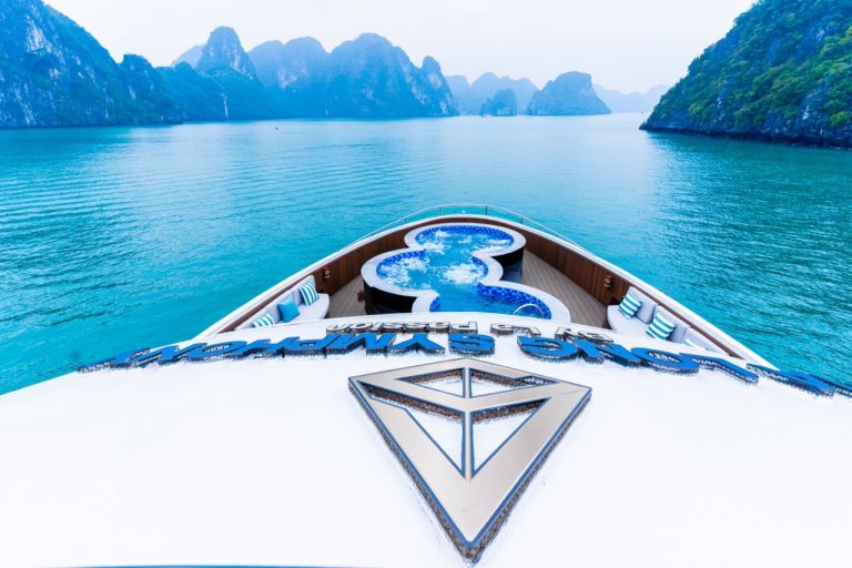 Stunning view from the cruise balcony overlooking Halong Bay's emerald waters and limestone karsts.