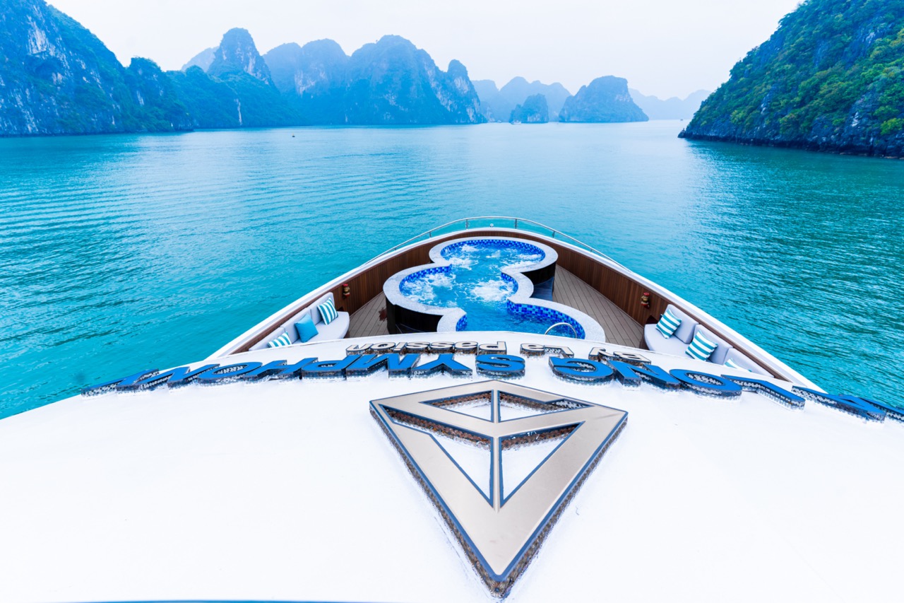Stunning view from the cruise balcony overlooking Halong Bay's emerald waters and limestone karsts.