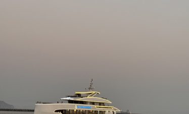Elegant cruise ship sailing on Halong Bay at sunset, showcasing luxury and scenic beauty.