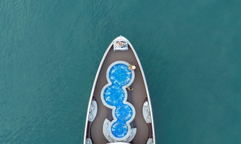 Stunning aerial view of a luxury cruise ship with a unique pool design in Halong Bay, showcasing a s.