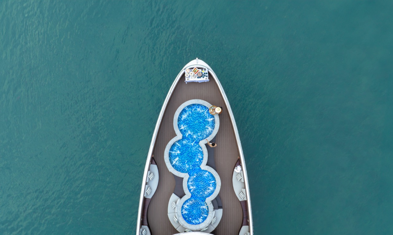 Stunning aerial view of a luxury cruise ship with a unique pool design in Halong Bay, showcasing a s.