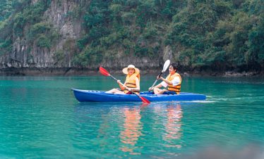 Kayaking in Halong Bay with scenic limestone cliffs and turquoise waters, perfect for an adventurous.