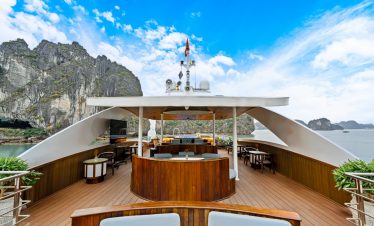 Stunning view from the cruise balcony overlooking limestone karsts and emerald waters of Halong Bay.