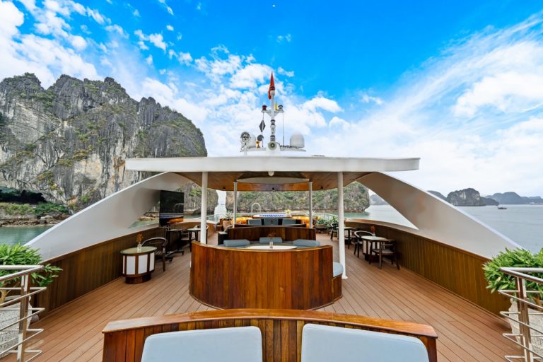 Stunning view from the cruise balcony overlooking limestone karsts and emerald waters of Halong Bay.