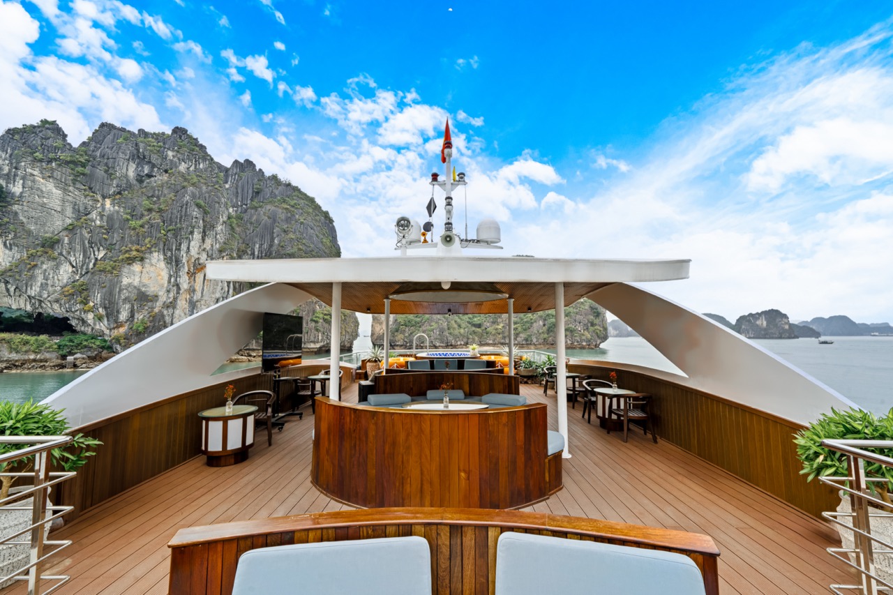 Stunning view from the cruise balcony overlooking limestone karsts and emerald waters of Halong Bay.