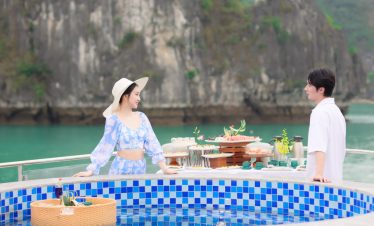 Scenic Halong Bay view with guests enjoying a luxurious cruise experience.
