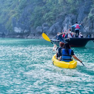 Paddles up—trace your own silver wake through glassy emerald water.