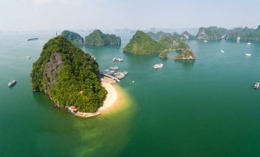 Aerial view of Halong Bay with lush islands and turquoise waters, perfect for a scenic cruise experi.