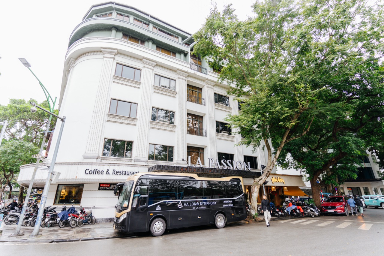 Modern cruise ship docked in Halong Bay for scenic day tour.
