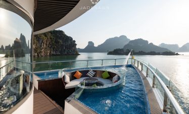 Luxury cruise balcony view in Halong Bay with scenic limestone islands.