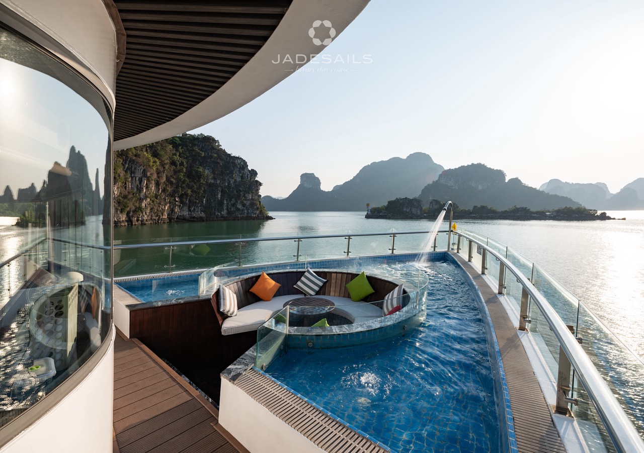 Luxury cruise balcony view in Halong Bay with scenic limestone islands.