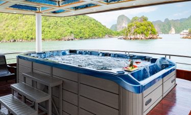 Luxury hot tub on Halong Bay cruise balcony with scenic limestone islands.