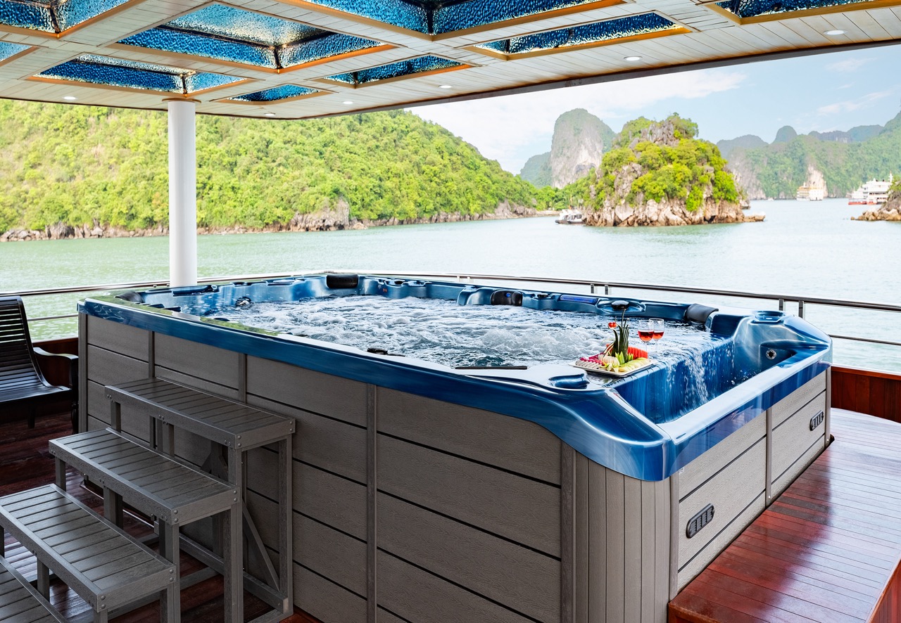 Luxury hot tub on Halong Bay cruise balcony with scenic limestone islands.