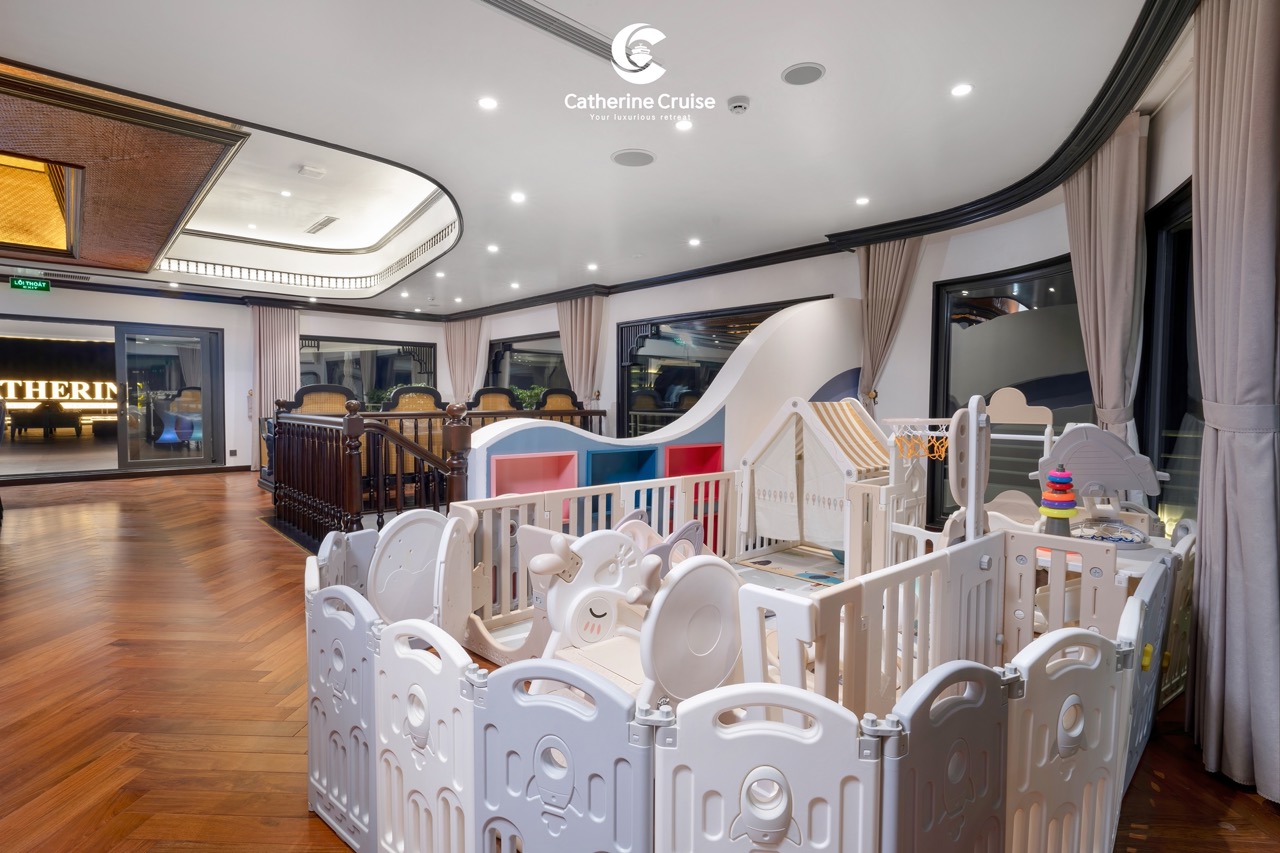 Modern indoor kids play area with colorful toys on wooden flooring, luxurious decor, and large windows.