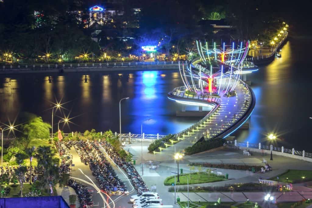 Mekong River illuminated at night with vibrant lights and scenic waterfront, perfect for a memorable.