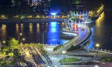 Mekong River illuminated at night with vibrant lights and scenic waterfront, perfect for a memorable.