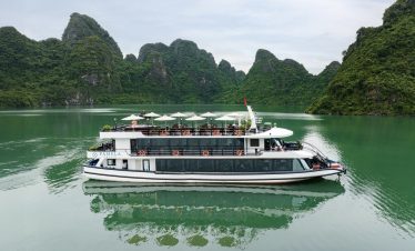 Luxury cruise boat on Halong Bay with stunning limestone karsts.