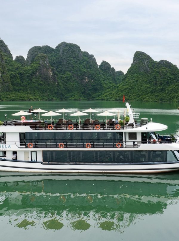 Luxury cruise boat on Halong Bay with stunning limestone karsts.