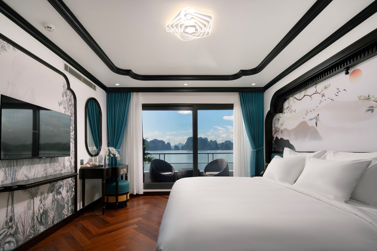 Luxury ocean view hotel room with balcony and modern decor.