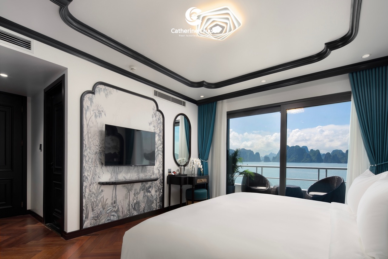 Luxurious hotel room with a balcony view of limestone islands and sea in Halong Bay, Vietnam.
