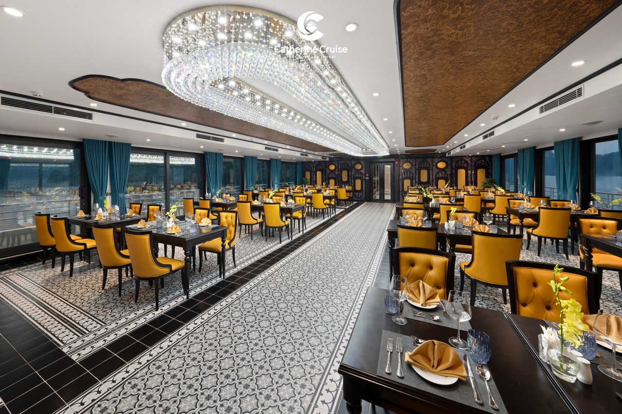 Elegant restaurant interior with yellow chairs, crystal chandelier, and decorative tiles, ideal for fine dining and events.