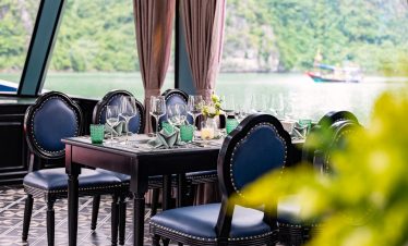 Luxurious cruise balcony overlooking Halong Bay with scenic views and serene atmosphere.