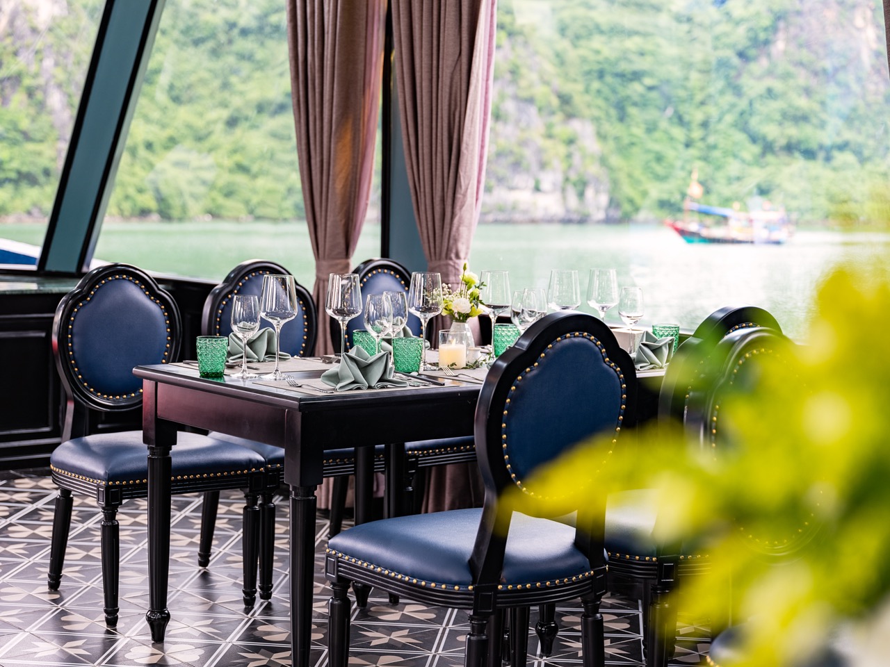 Luxurious cruise balcony overlooking Halong Bay with scenic views and serene atmosphere.