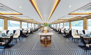 Luxurious cruise dining room with panoramic views of Halong Bay, perfect for a memorable travel expe.
