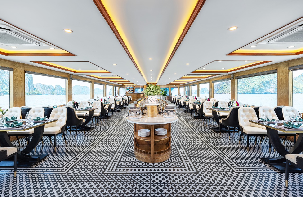 Luxurious cruise dining room with panoramic views of Halong Bay, perfect for a memorable travel expe.