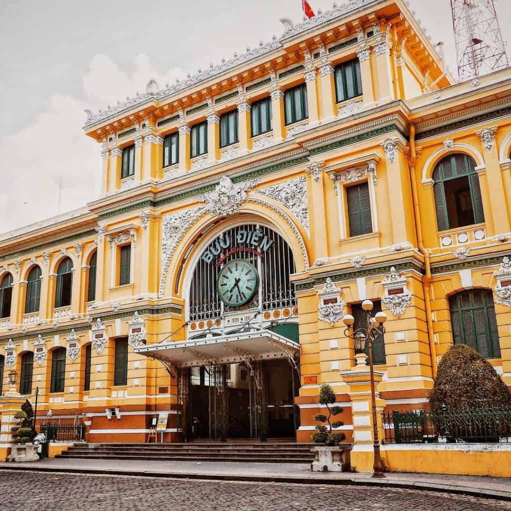 Ho Chi Minh City Post Office exterior showcasing colonial architecture and vibrant yellow facade.