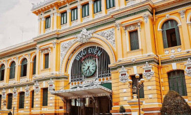 Ho Chi Minh City Post Office exterior showcasing colonial architecture and vibrant yellow facade.