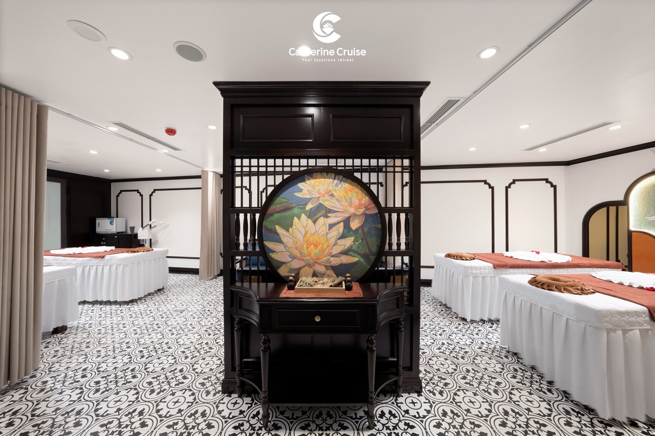 Elegant spa massage room with traditional Asian decor and lotus artwork, perfect for relaxation.