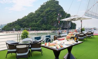 Scenic view of Halong Bay from a cruise balcony with lush green island and calm waters, perfect for.