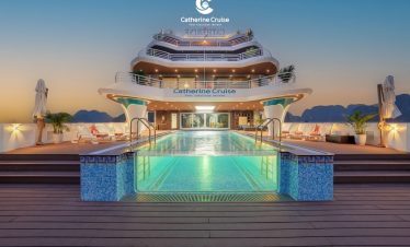 Stunning cruise ship deck with infinity pool at sunset, luxury travel and vacation experience.