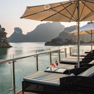 Loungers facing the bay at sunset on Jade Sails.