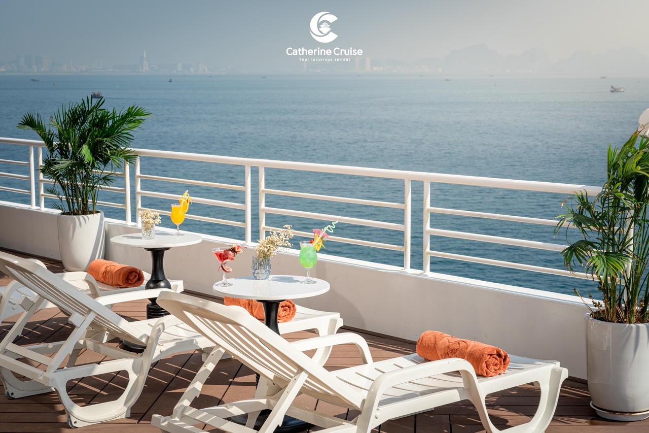 Relaxing seaside cruise deck with drinks and sun loungers - perfect vacation spot.
