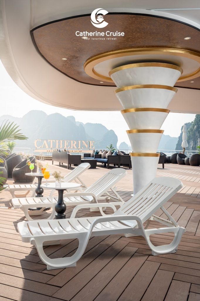 Elegant yacht deck with lounge chairs and scenic mountain views for luxury cruising.