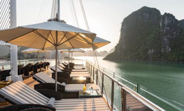 Cruise balcony overlooking Lan Ha Bay with scenic limestone karsts and calm waters.