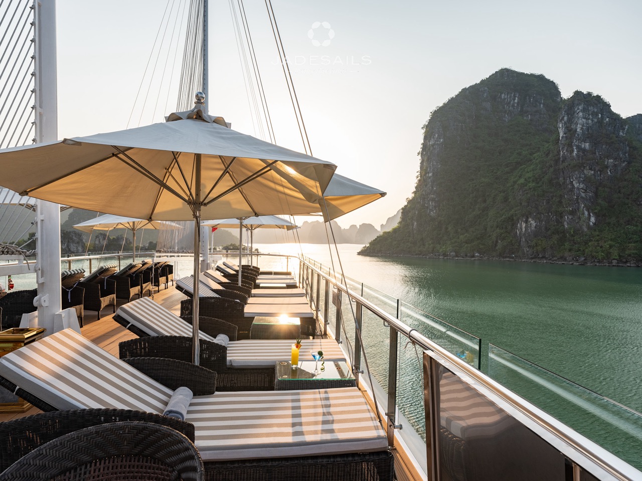 Cruise balcony overlooking Lan Ha Bay with scenic limestone karsts and calm waters.