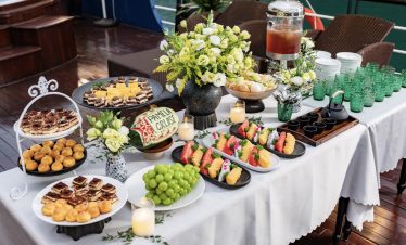 Luxurious Halong Bay cruise balcony with gourmet treats and fresh flowers, perfect for a memorable s.