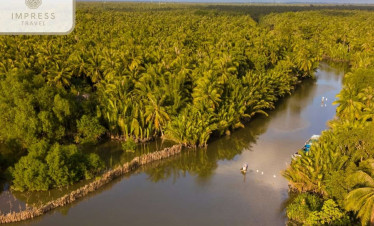 Mekong Delta river scene with lush greenery and boats cruising, showcasing Vietnam's natural beauty.