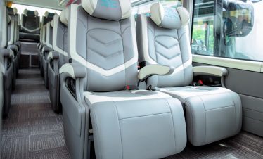 Luxury bus seats on Heritage Cruise for Halong Bay exploration, comfortable travel experience.