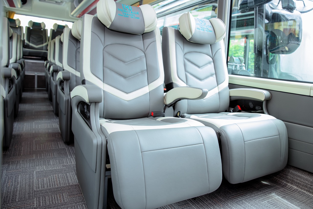Luxury bus seats on Heritage Cruise for Halong Bay exploration, comfortable travel experience.